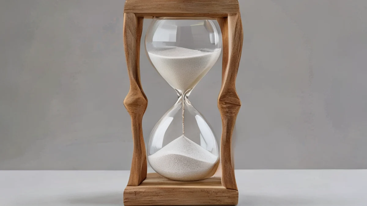 An hourglass with sand flowing from the top to the bottom.